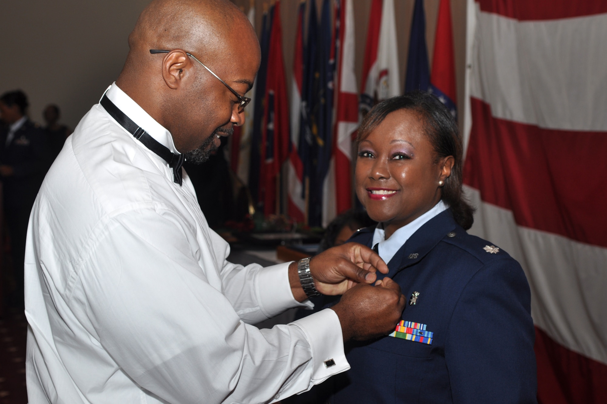Andre’ Kimble attaches a retirement pin to the lapel of his sister, Lt. Col. Beverly Lewis during her retirement ceremony in Hoban Hall at Barksdale Air Force Base, La., Oct. 13, 2012. The ceremony included many presentations to Lewis in honor of her retirement, as well as a dance tribute. Songs were performed by recording artist Zelia Logan and a proclamation was made by Jonesboro La., Mayor Leslie Cornell Thompson.  A reception followed the ceremony. (U.S. Air Force photo by Master Sgt. Jeff Walston/Released)  