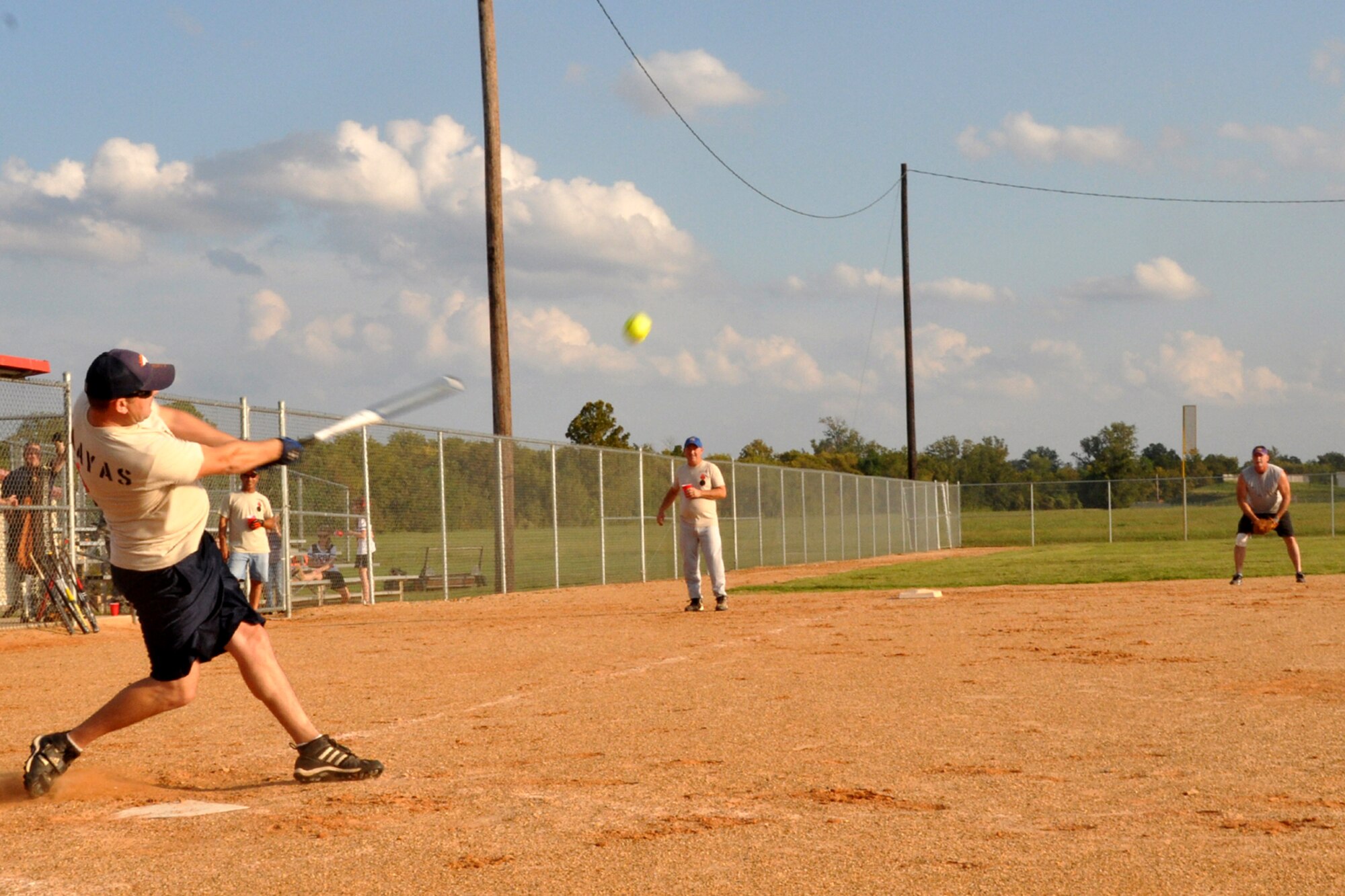 Corey Parchman launches a ball deep into left field during a softball game at Barksdale Air Force Base, La., Oct. 13, 2012.  The hit resulted in a triple for Parchman as he was able to sprint to third base, just beating the throw in from the outfield.  The game, held between members of the 307th Maintenance Squadron, drew a large crowd of spectators and participants. (U.S. Air Force photo by Staff Sgt. Ted Daigle/Released)