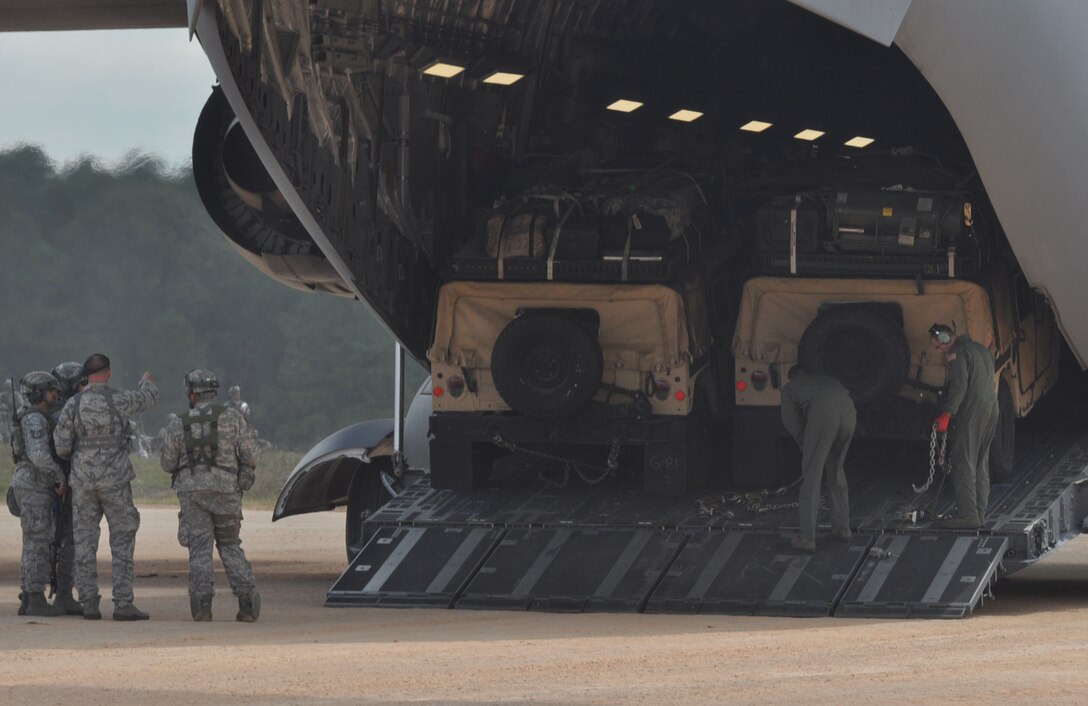 Humvees and their cargo are unloaded from a C-17 during a Joint Readiness Training Center exercise Oct. 10, 2012, at Ft. Polk La. More than 5,000 Army and Air Force personnel participated in the joint training exercise. (U.S. Air Force photo by Staff Sgt. Jacob Barreiro)