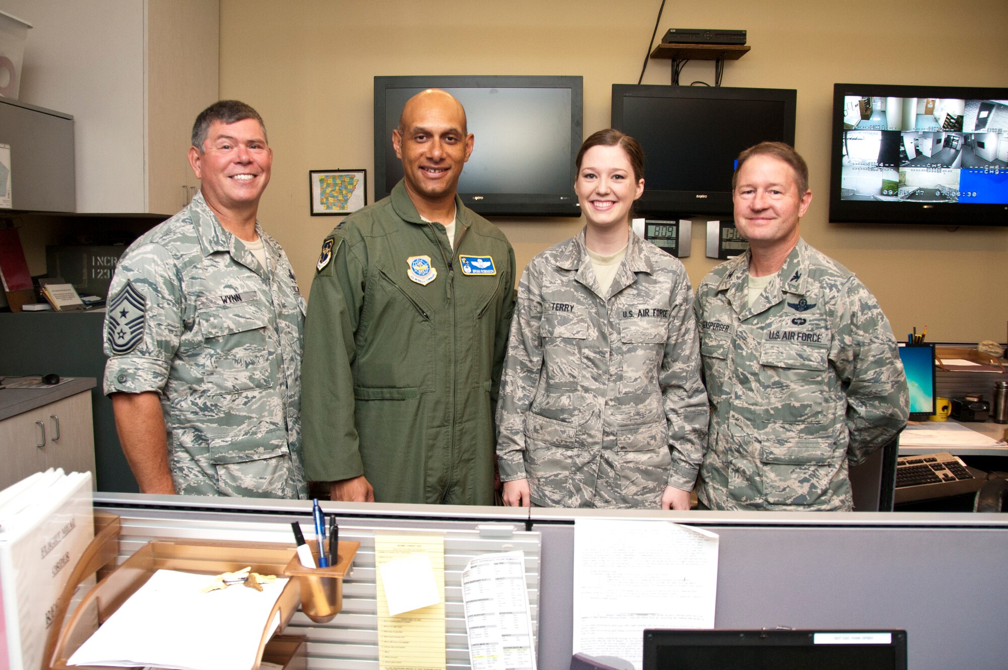 Chief Gary Wynn, 189th Airlift Wing command chief, Col. Brian Robinson, 19th Airlift Wing commander, and Col. Steve Eggensperger, 189th Airlift Wing commander, congratulate Senior Airman Meagan Terry, a 189th Airlift Wing command post journeyman, for being chosen as Combat Airlifter of the Week Sept. 15, 2012 at Little Rock Air Force Base, Ark. Meagan, a Russellville, Ark., native, revitalized the publications program as the publication manager and brought it from the analog age into the digital age, ensuring current available publications. (U.S. Air Force photo by Airman 1st Class Ian Caple)
