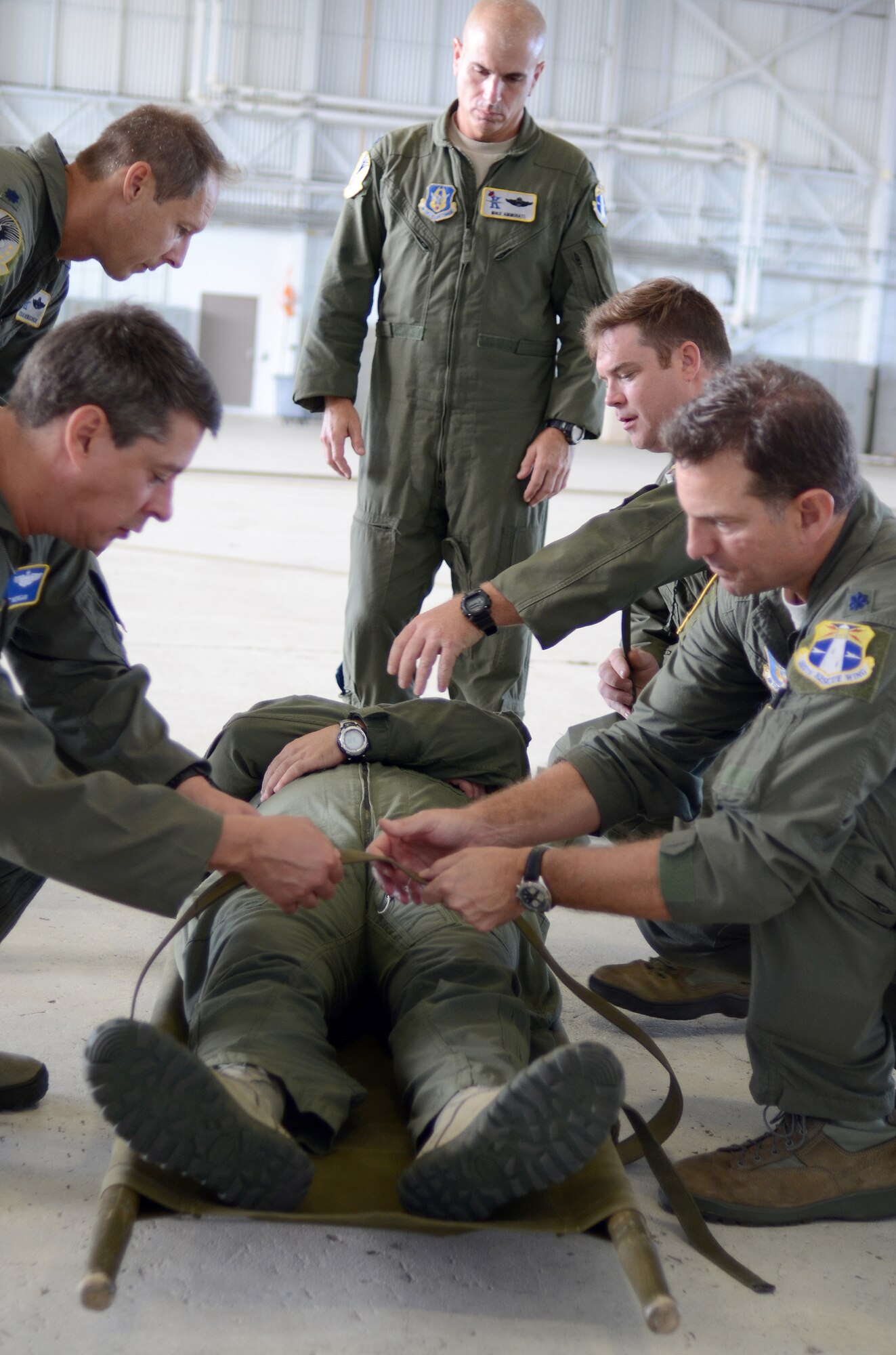 Rescue Reservists from the 920th Rescue Wing learn how to property secure a patient onto a rescue litter during Self Aid, Buddy Care training at the Wing's Unit Training Assembly Sunday. Reserve Airmen continue their training for a Combined Unit Inspection that test the skills and preparedness of the Reservists during scenarios that mimic what they may find while deployed in a combat environment. They will have their deployment readiness tested with an official grade by an inspection team during the final phase of the Inspection slated for April 2013. (U.S. Air Force photo/2nd Lt. Leslie Forshaw)