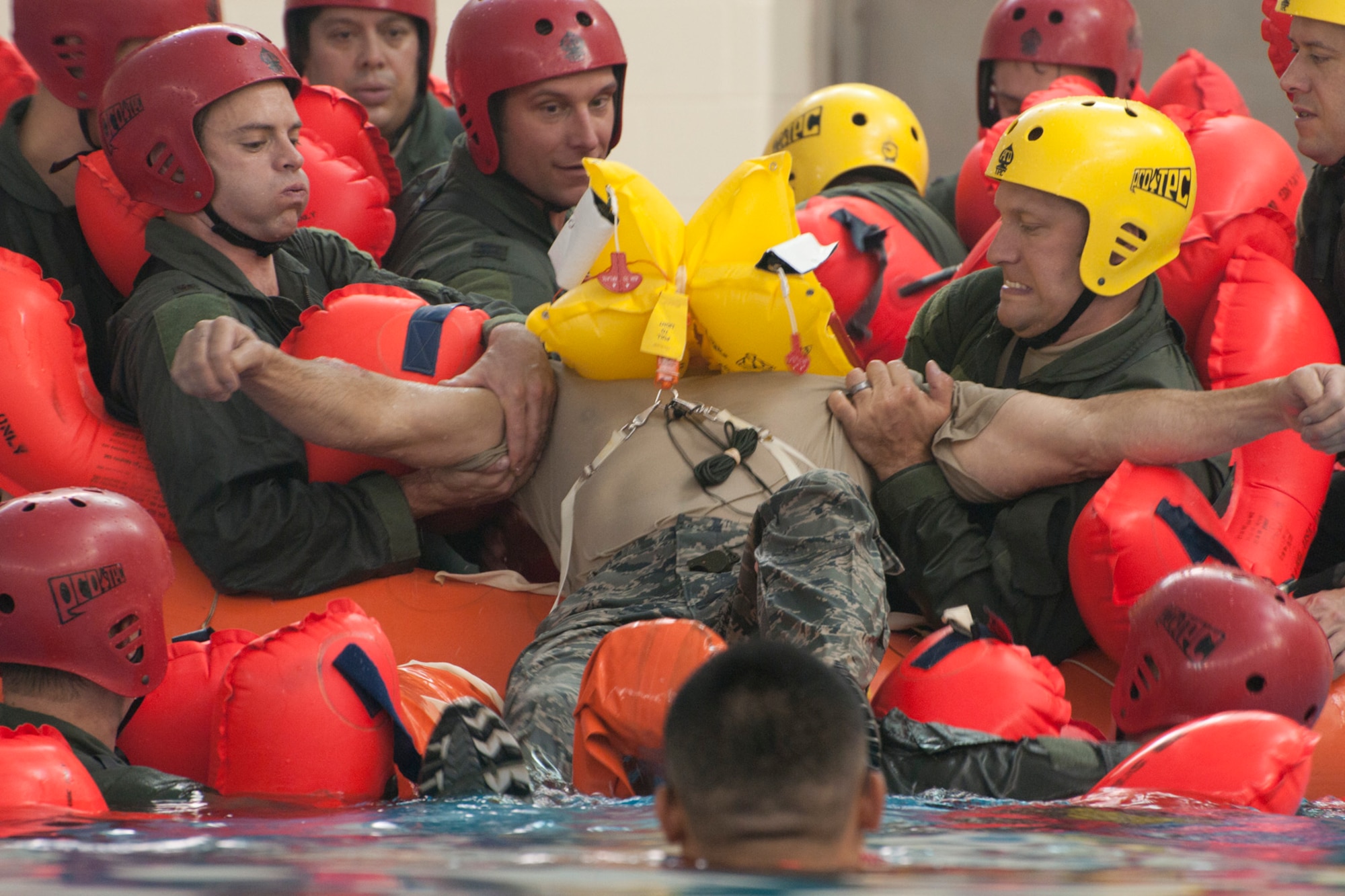 Airmen from the 171st Air Refueling Squadron, work together to pull an “injured” Airman out of the water during survival training in the pool of L’Anse Cruese North High School, near Selfridge Air National Guard Base, Mich., Oct. 16, 2012. Since Air Force air crews operate in a worldwide environment, they must train for every contingency scenario, including the possibility of a downed aircraft in an ocean or lake.  The 171st flies the KC-135 Stratotanker, which can carry approximately 50 passengers. (Air National Guard photo by TSgt. Robert Hanet)