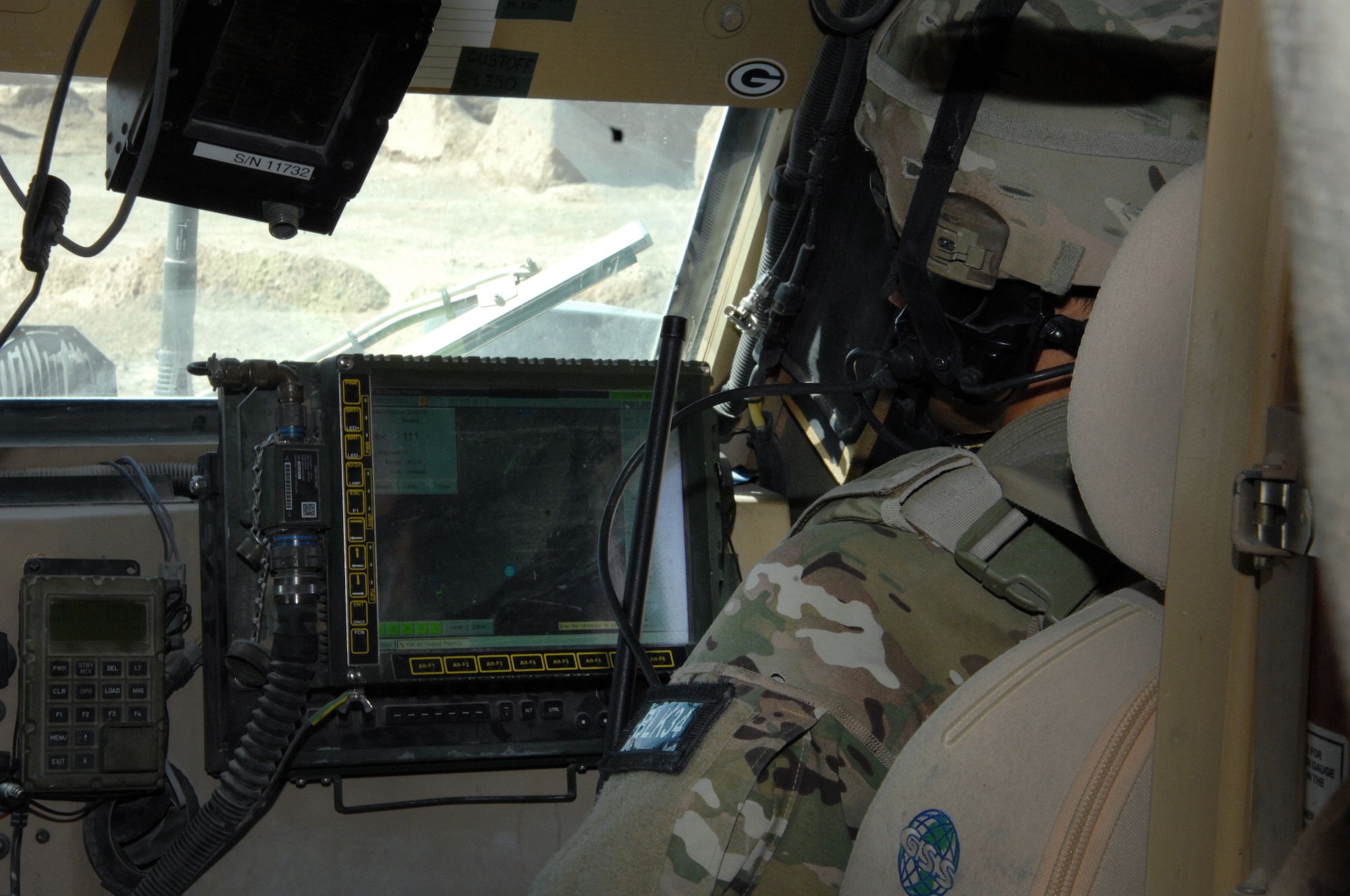 An Airman monitors navigation equipment en-route to a local village to distribute humanitarian aid recently. The band of Airmen delivered more than 5,000 pounds of supplies to include, rice, grain, toys and school supplies to local villagers. (U.S. Air Force photo/Master Sgt. Russell Martin)