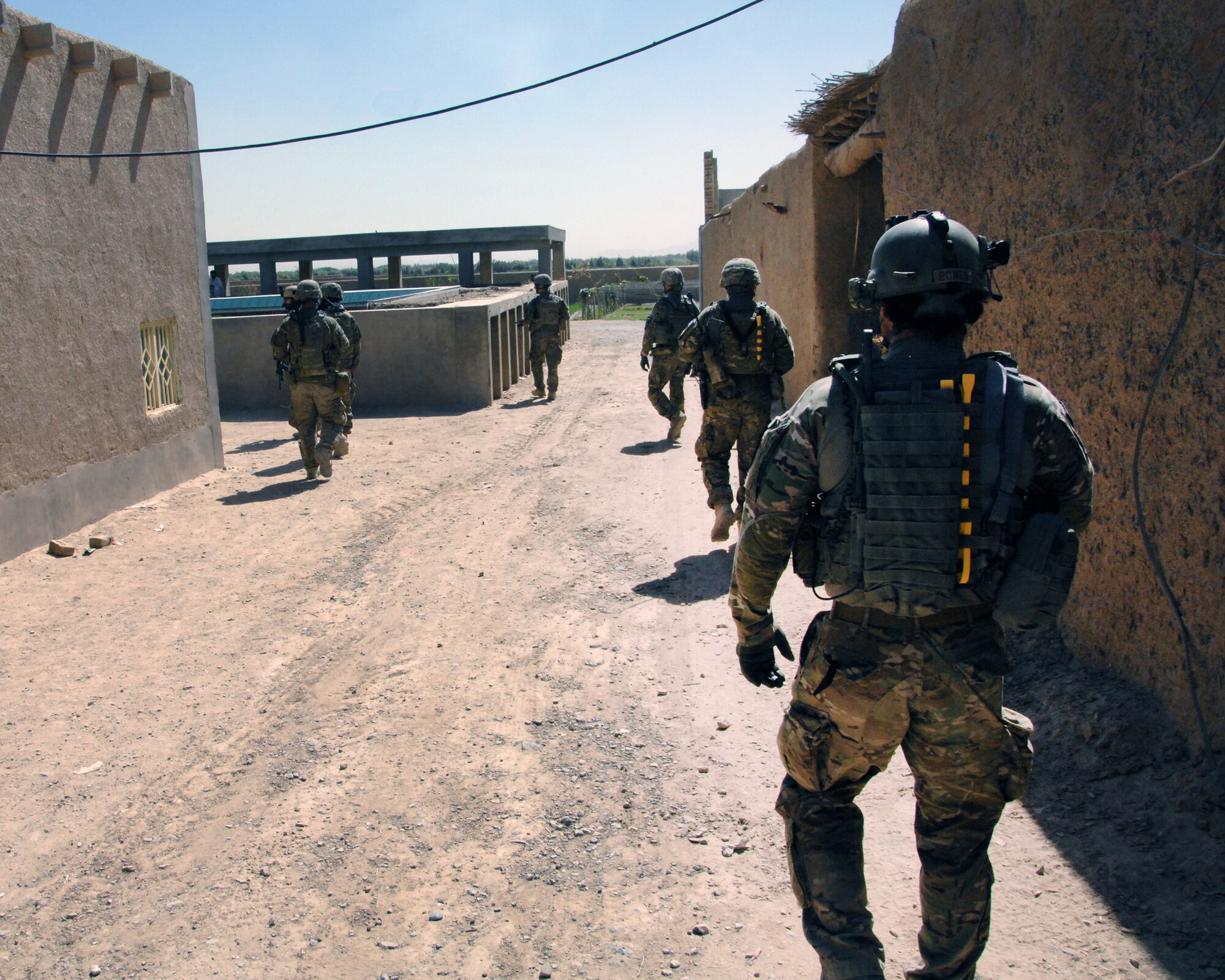 Airmen from KAF walk the streets of a local village while delivering humanitarian aid to local villagers. The Airmen delivered more than 5,000 pounds of aid to the locals. The cargo included grains, rice, toys for the children, as well as school supplies. Airmen routinely stock up on supplies that can be donated to the communities to help strengthen coalition relationships with community members. (U.S. Air Force photo/Master Sgt. Russell Martin)