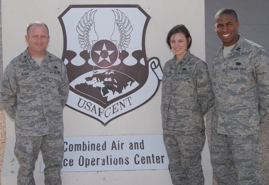 Maj. Bary Flack (left), 1st Lt. Amanda Elliott and Capt. Allen Batiste, all from the U.S. Air Forces Central Command Air Mobility Division airlift control team, pose for a group photo Oct. 15, 2012 in front of the Combined Air and Space Operations Center, Southwest Asia. In addition to moving intra-theater passengers in standard rotational movements, AMD teams also coordinate aeromedical evacuation missions, refueling operations, cargo transportation, and airdrops. (U.S. Air Force photo/Tech. Sgt. Mike Andriacco)