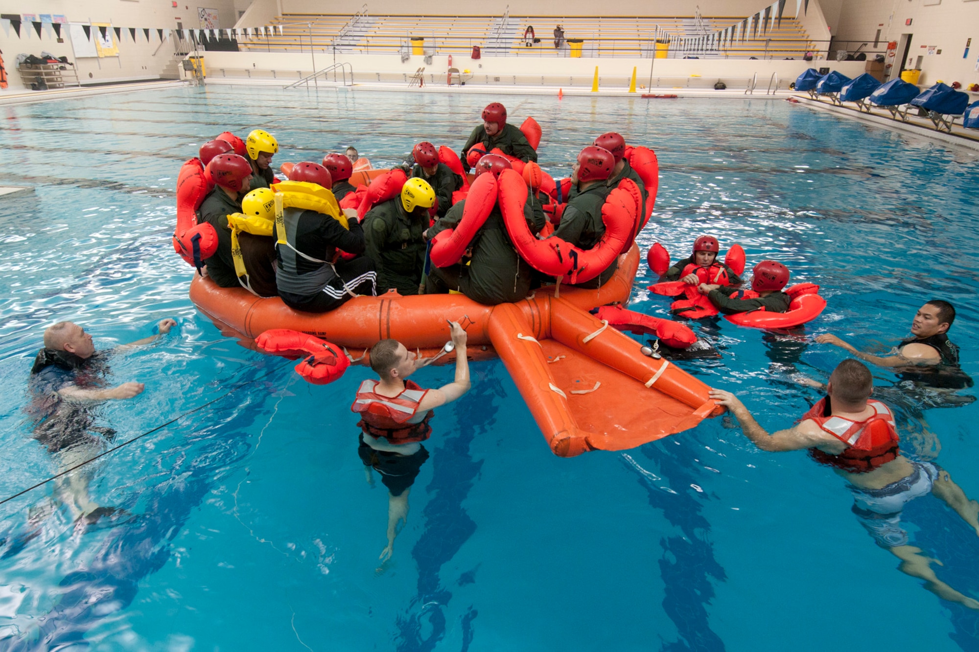 Airmen from the 171st Air Refueling Squadron sit in an emergency life raft during a water survival training exercise in the pool of L’Anse Cruese North High School, near Selfridge Air National Guard Base, Mich., Oct. 16, 2012. Since Air Force air crews operate in a worldwide environment, they must train for every contingency scenario, including the possibility of a downed aircraft in an ocean or lake.  The 171st flies the KC-135 Stratotanker, which can carry approximately 50 passengers. (Air National Guard photo by TSgt. Robert Hanet)