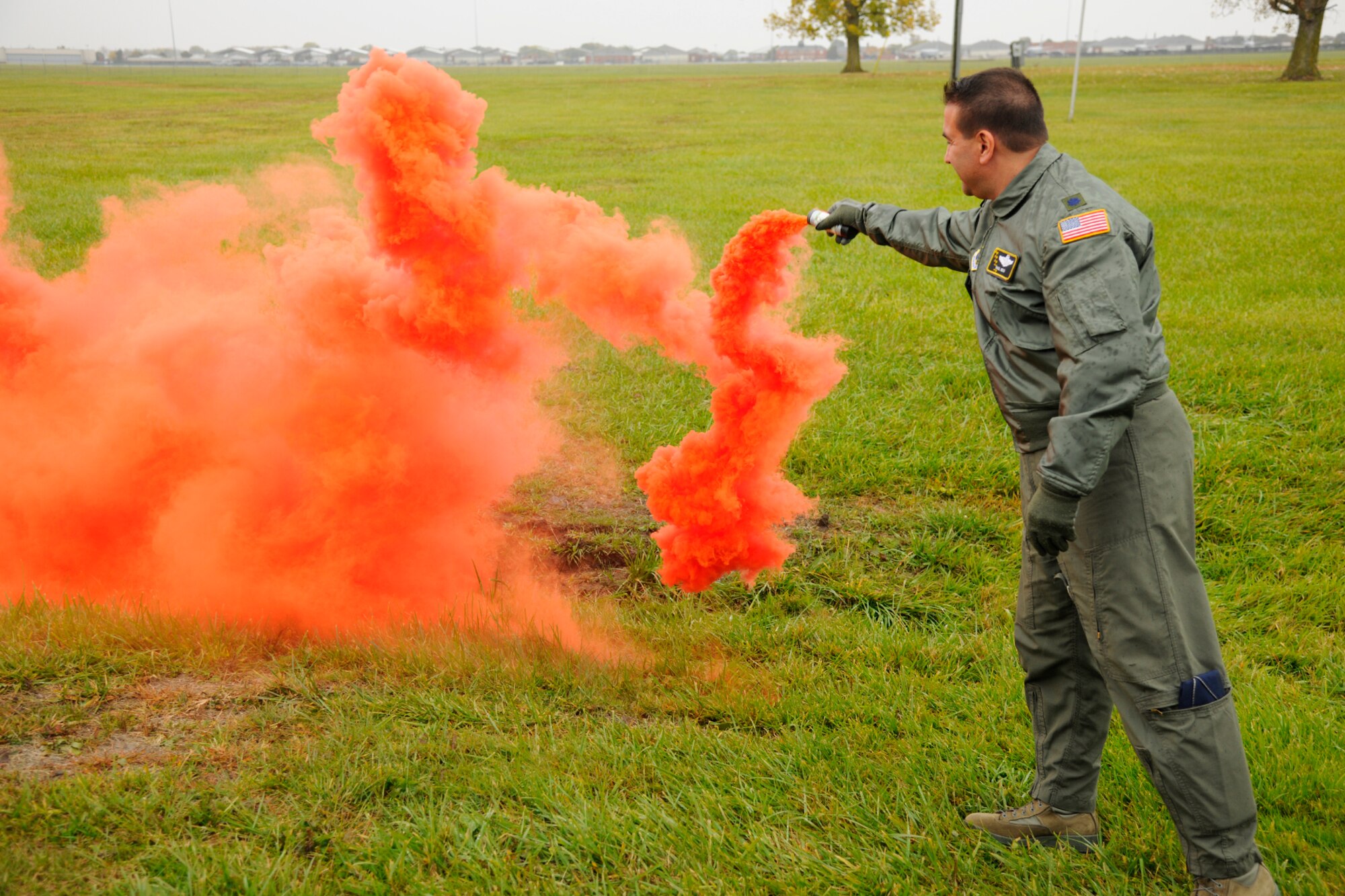 Lt. Col. Paul Beck, a KC-135 Stratotanker pilot with the 171st Air Refueling Squadron uses a smoke canister to mark his location during survival training at Selfridge Air National Guard Base, Mich., Oct. 13, 2012. Air crew personnel with the squadron spent two days working on a series of exercises designed to help them survive a down aircraft scenario and signal for help from a rescue mission. (Air National Guard photo by TSgt. David Kujawa)