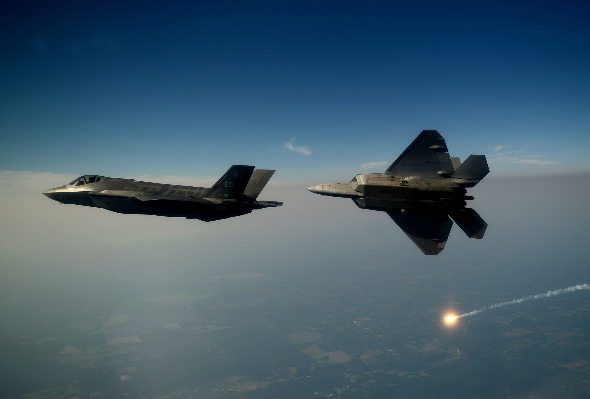 An F-35A Lightning II joint strike fighter from the 33rd Fighter Wing at Eglin Air Force Base, Fla., and an F-22A Raptor from the 43rd Fighter Squadron at Tyndall Air Force Base, Fla., soar over the Emerald Coast Sept. 19, 2012. This was the first time the two fifth-generation fighters have flown together for the Air Force. (U.S. Air Force photo/Master Sgt. Jeremy T. Lock) 
