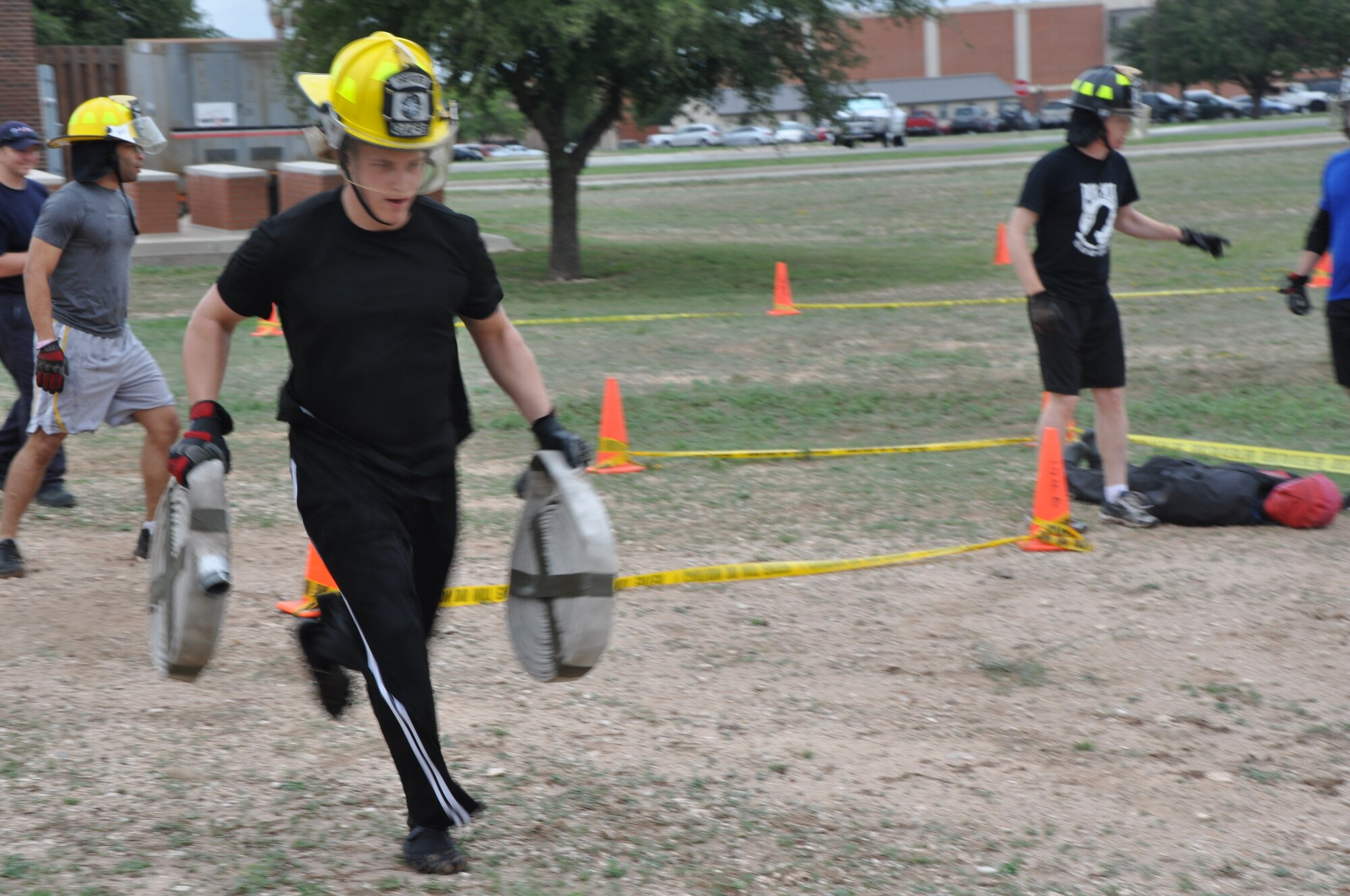 GOODFELLOW AIR FORCE BASE, Texas – Staff Sgt. Eric Messer, 17th Communications Squadron server administrator, runs the hose carry portion of the Firefighter Muster at the Fire Department Oct. 12. The Firefighter Muster was held in celebration of National Fire Prevention Week, which was Oct. 7 to 13. (U.S. Air Force photo/ Airman 1st Class Joshua Edwards)