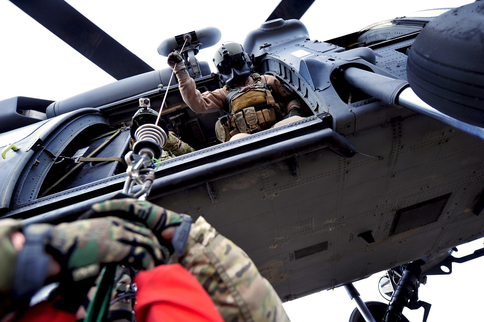 U.S. Air Force Staff Sgt. Brandon Taylor, 33rd Rescue Squadron flight engineer, hoists simulated survivors into a 33rd RQS HH-60 Pave Hawk as part of a combat search and rescue scenario for Exercise Pacific Thunder near Osan Air Base, Republic of Korea, Oct. 15, 2012. Pacific Thunder is an annual two-week exercise that involves the 31st and 33rd RQS from Kadena AB, Japan, and the 25th Fighter Squadron from Osan. These units work together to practice combat search and rescue tactics to prepare for real-world emergency situations. (U.S. Air Force photo/Staff Sgt. Sara Csurilla)