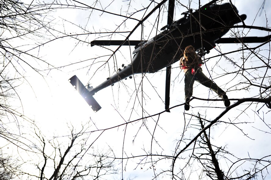 U.S. Air Force Staff Sgt. Dane Hatley, a 33rd Rescue Squadron flight engineer, is hoisted into a 33rd RQS HH-60 Pave Hawk as part of a combat search and rescue scenario for Exercise Pacific Thunder near Osan Air Base, Republic of Korea, Oct. 15, 2012. Pacific Thunder is an annual two-week exercise that involves the 31st and 33rd RQS from Kadena AB, Japan, and the 25th Fighter Squadron from Osan. These units work together to practice combat search and rescue tactics to prepare for real-world emergency situations. (U.S. Air Force photo/Staff Sgt. Sara Csurilla)