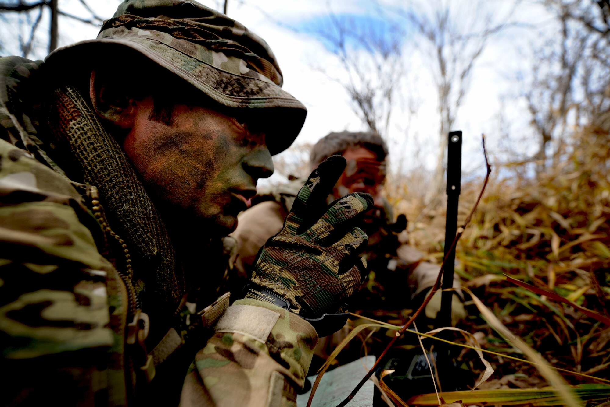 U.S. Air Force Tech. Sgt. Bobby Colliton, 18th Operation Support Squadron survival evasion resistance and escape specialist from Kadena Air Base, Japan, instructs U.S. Air Force Staff Sgt. Dane Hatley, a 33rd Rescue Squadron flight engineer, while performing combat survival training during Exercise Pacific Thunder near Osan Air Base, Republic of Korea, Oct. 15, 2012. Pacific Thunder is an annual two-week exercise that involves the 31st and 33rd RQS from Kadena and Osan's 25th Fighter Squadron. These units work together to practice combat search and rescue tactics to prepare for real-world emergency situations.(U.S. Air Force photo/Staff Sgt. Sara Csurilla)