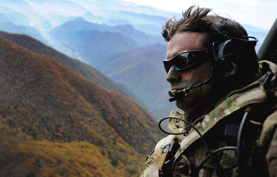 U.S. Air Force Tech. Sgt. Bobby Colliton, 18th Operation Support Squadron survival evasion resistance and escape specialist from Kadena Air Base, Japan, looks out of an HH-60 Pave Hawk after performing combat survival training with a 33rd Rescue Squadron aircrew member during Exercise Pacific Thunder near Osan Air Base, Republic of Korea, Oct. 15, 2012. Pacific Thunder is an annual two-week exercise that involves the 31st and 33rd RQS from Kadena AB, Japan, and the 25th Fighter Squadron from Osan. The units work together to practice combat search and rescue tactics to prepare for real-world emergency situations.(U.S. Air Force photo/Staff Sgt. Sara Csurilla)
