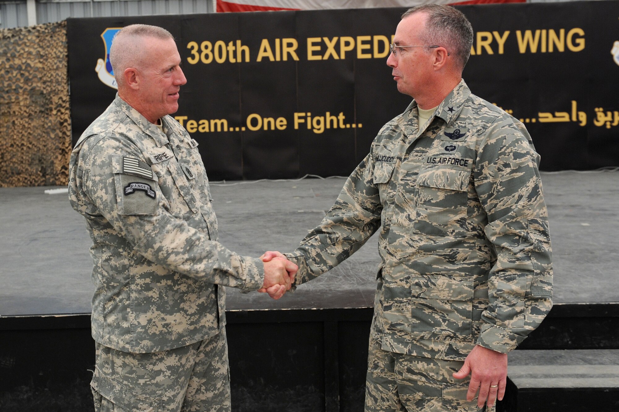 SOUTHWEST ASIA - U.S. Army Command Sgt. Maj. Frank Grippe, U.S. Central Command senior enlisted leader, shakes hands with U.S. Air Force Brig. Gen. Paul McGillicuddy, 380th Air Expeditionary Wing commander, after speaking to Airmen and Soldiers here Oct. 11, 2012. Grippe said he couldn’t think of a better mission statement than that of the 380th AEW: “Execute Today, Prepare for Tomorrow.” (U.S. Air Force photo/Master Sgt. Scott MacKay)