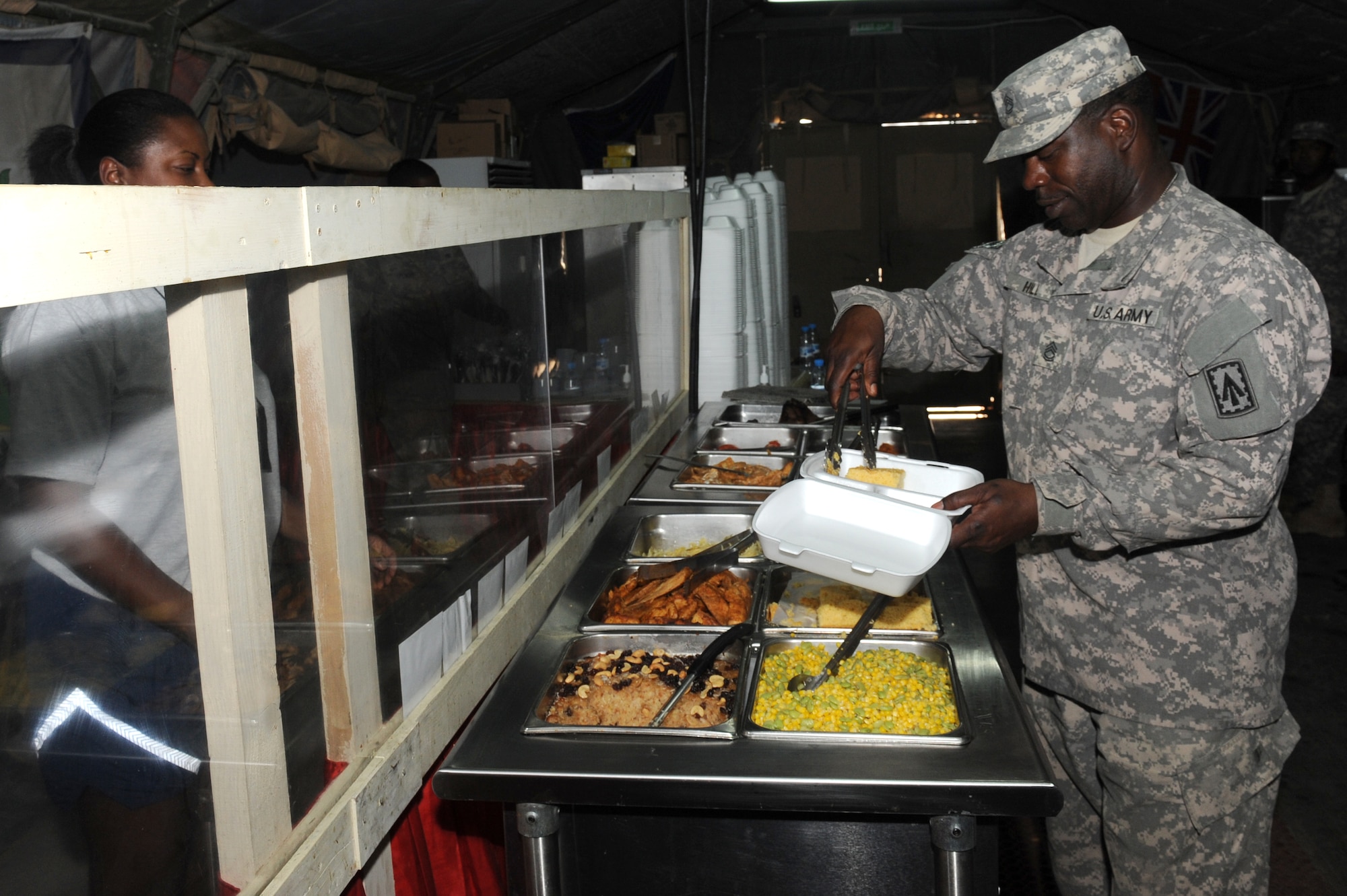 SOUTHWEST ASIA - Sgt. 1st Class Samueal Hill, Windy’s dining facility manager, serves customers in the Windy's dining facility at the 380th Air Expeditionary Wing Oct. 10, 2012. Hill, a Dallas native, is deployed here with the 1st Battalion, 7th Air Defense Artillery Regiment from Fort Bragg, N.C. (U.S. Air Force photo/Master Sgt. Scott MacKay)