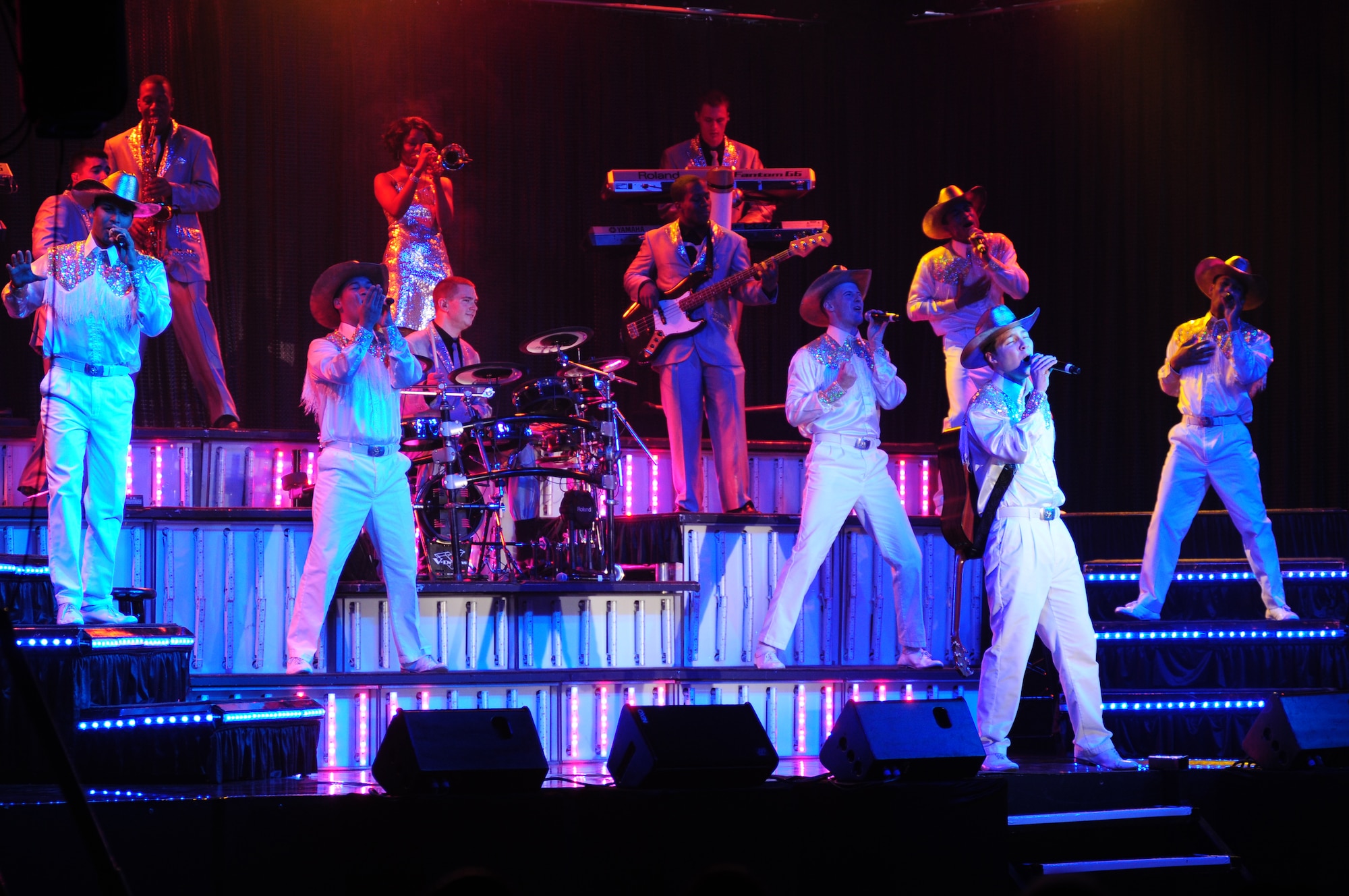 ROYAL AIR FORCE LAKENHEATH, England – Members of Tops In Blue perform at Hangar 7 Oct. 11, 2012. The Tops In Blue 2012 World Tour, entitled “Listen,” features songs by Whitney Houston, Maroon 5, Carrie Underwood, Lady Antebellum and many others. Tops In Blue tours every year visiting stateside bases and overseas locations providing entertainment for Airmen, families and members of the local community.  (U.S. Air Force photo by Airman 1st Class Cory D. Payne)