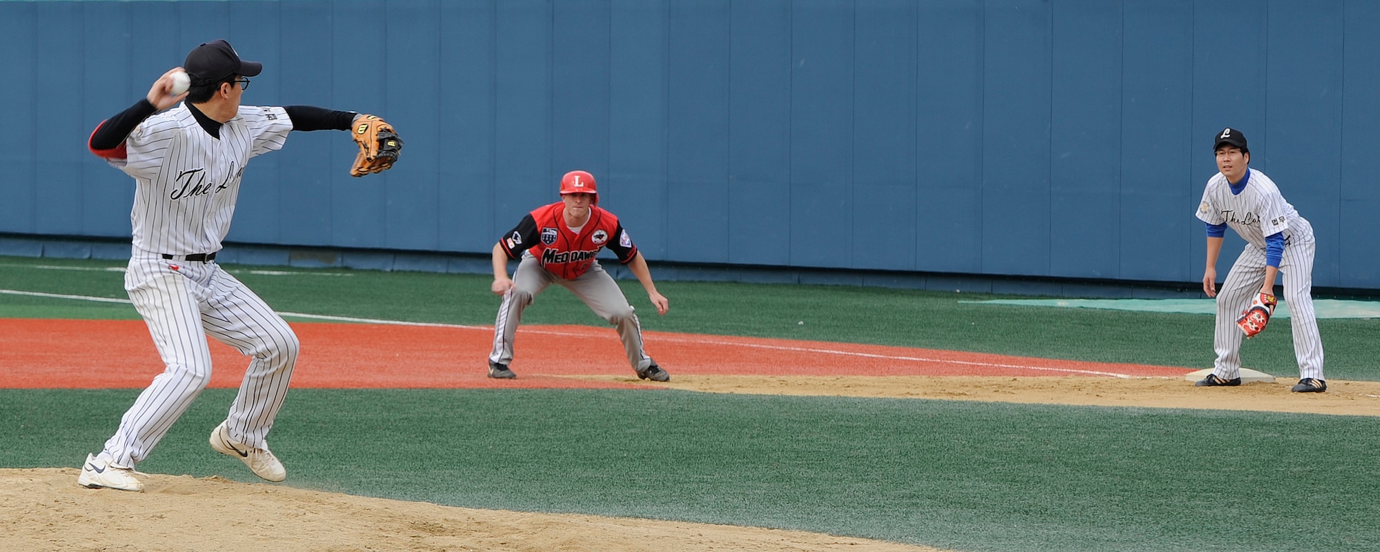 1st Lt. David Lutz, 8th Medical Operations Squadron, steals second base as members of the local Gunsan team ‘The Law’ try to get him out at Gunsan City Sports Stadium, Republic of Korea, Oct. 13, 2012. Although he was picked off, Lutz was able to out maneuver the other team as he dove into second base just before without being tagged. (U.S. Air Force photo/Senior Airman Marcus Morris)