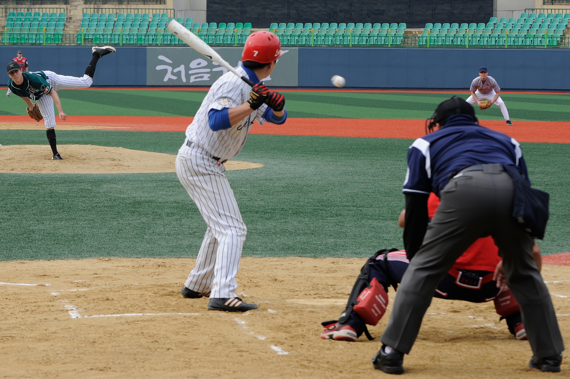 Senior Airman Cody Green, 8th Fighter Wing command post, pitches the ball to a member of the local Gunsan team ‘The Law’ at Gunsan  City Sports Stadium, Republic of Korea, Oct. 13, 2012. Green struck out many of ‘The Law’ members during the game preventing them from scoring more than 6 runs. (U.S. Air Force photo/Senior Airman Marcus Morris) 