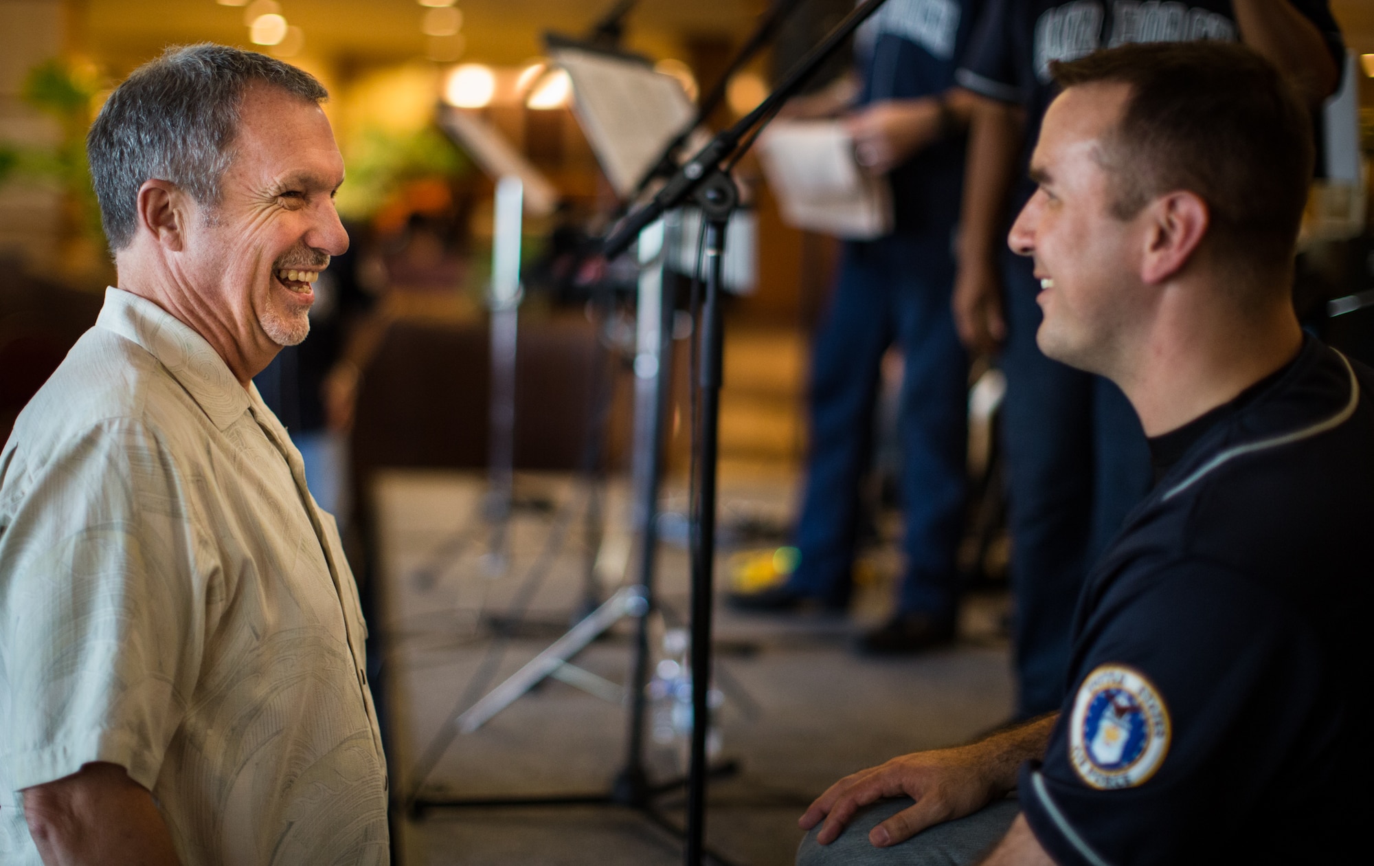 TUMON BAY, Guam -- Senior Airman William Pressgrove, Band of the Pacific-Asia vocalist, talks with a man at the Outrigger Hotel, Tumon Bay, Guam, on Oct. 14, 2012. The band took advantage of several opportunites to talk about the Air Force Bands' mission after the concert. (U.S. Air Force photo/Staff Sgt. Josh Voyles)