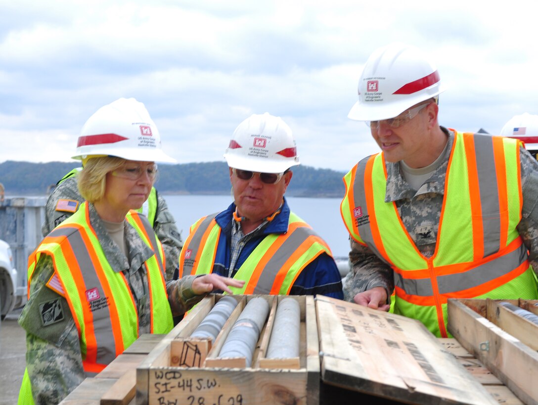 Brig. Gen. Margaret W. Burcham, Great Lakes and Ohio River Division commander and Capt. Erik Patton, Division Engineer Aide, looks at core samples taken from the barrier wall with Bernie Kearns, materials engineering technician for the Wolf Creek Remediation Project, during Burcham’s first visit to the Wolf Creek Dam on Oct. 10, 2012. (USACE photo by Amy Redmond)