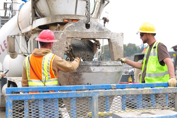 Project contractors fill a bucket with concrete for work being completed to the barrier wall at the Wolf Creek Foundation Remediation Project on Oct 10, 2012. (USACE photo by Amy Redmond)