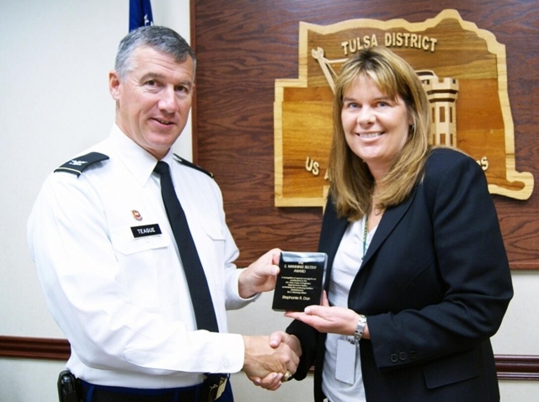Tulsa District U.S. Army Corps of Engineers attorney Stephanie R. Darr, the district's labor counselor, is presented the E. Manning Seltzer Award by District Commander Col. Michael Teague. The award recognizes a Corps attorney who has made one or more special contributions to the Corps' legal services mission. The contribution may result from the development of a legal theory or application in any field of law, legal management innovation or practice, or outstanding performance in solving a legal or management problem.