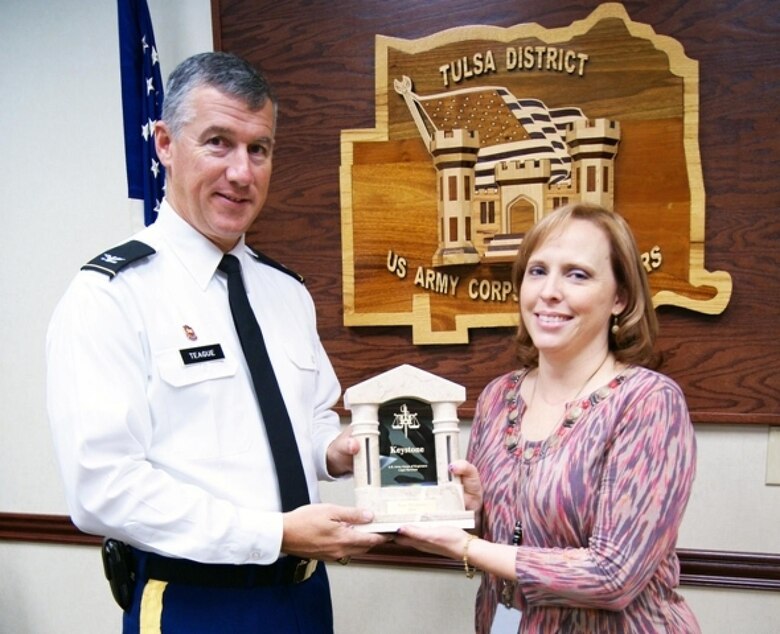 Raye Thornton, a paralegal with the Tulsa District U.S. Army Corps of Engineers' Office of Counsel, is presented the prestigious USACE Chief Counsel Keystone Award by District Commander Col. Michael Teague. The award recognizes professionalism and valued service of an individual member or of a team comprised of members of the USACE Legal Services System who made a significant contribution to the Corps Legal Services System and its mission.