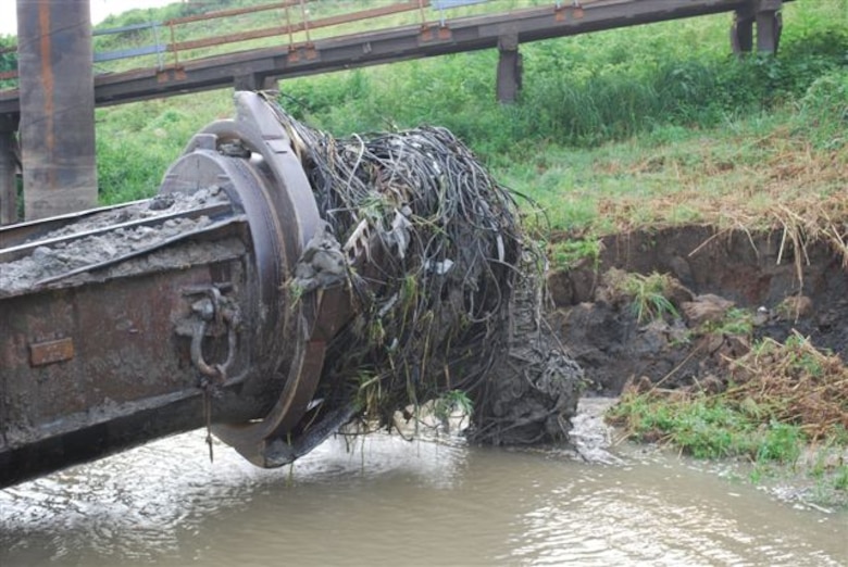 The business end of the contract cutterhead dredge Venture lifts out of the water at Elvis Stahr Harbor at Hickman, KY.