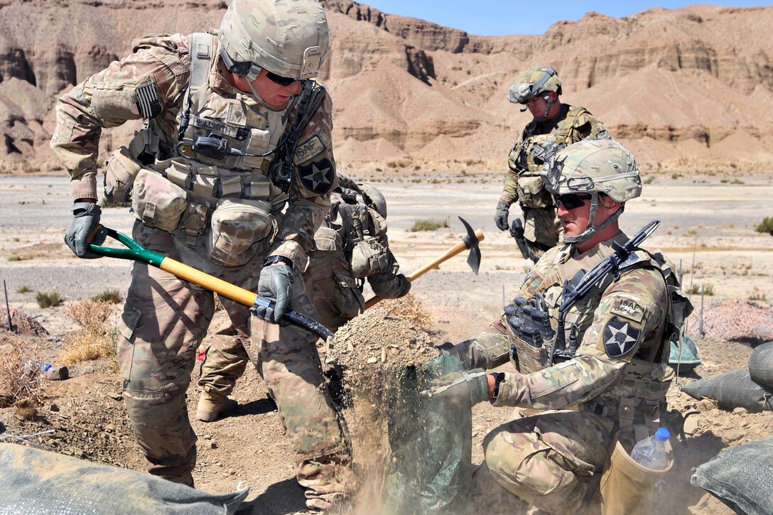 U.S. Army Spc. Justin Heimsoth, left, and U.S. Army Sgt. Chris Hagen fill sandbags to anchor a machine gun during Operation Southern Fist in the Spin Boldak district in Afghanistan's Kandahar province, Sept. 29, 2012. Heimsoth and Hagen, infantrymen, are assigned to the 2nd Infantry Division's 5th Battalion, 20th Infantry Regiment, 3rd Stryker Brigade Combat Team.