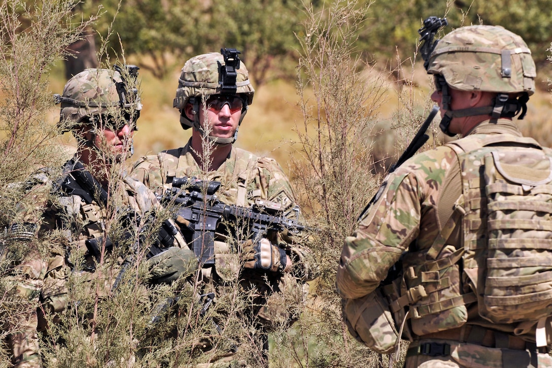 U.S. Army 1st Lt. Patrick Ryan, center, talks with other soldiers during Operation Southern Fist in Obezhan Kalay village in the Spin Boldak district in Afghanistan's Kandahar province, Sept. 30, 2012. Ryan, an infantry officer, is assigned to the 2nd Infantry Division's Security Force Assistance Team 8, 20th Infantry Regiment, 3rd Stryker Brigade Combat Team.