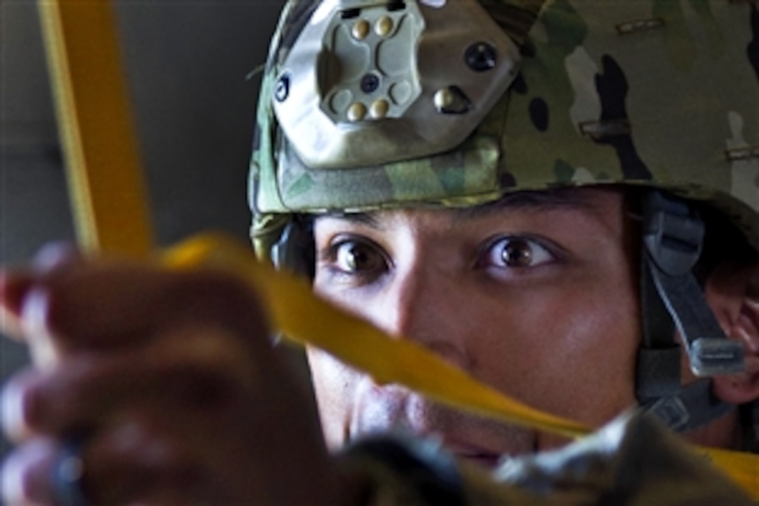 An Army paratrooper prepares to jump from a C-17 Globermaster III during an exercise using Air Force aircraft to drop troops and cargo on Fort Bragg, N.C., Oct. 11, 2012. The soldier is assigned to the 82nd Airborne Division.