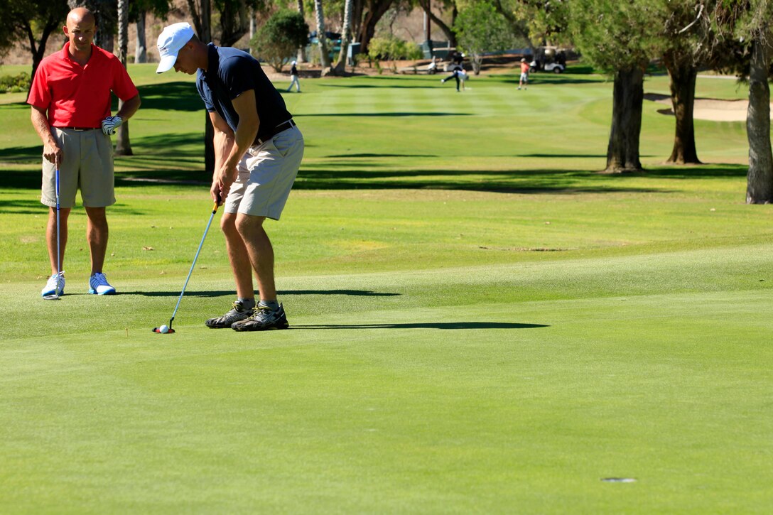 Cpl. Luke T. Meaney, a correctional specialist and also official driver for the the commanding general, MCIWest-MCB Camp Pendleton, prepares to sink the ball during the Commanding General’s 1st Invitational Golf Tournament at Camp Pendleton’s Marine Memorial Golf Course, Oct. 15.