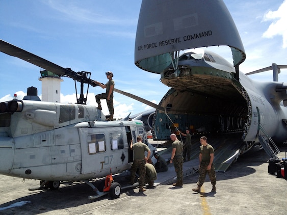 U.S. Marines with Detachment Martillo load a UH-1N "Huey" helicopter on an Air Force C-5 "Galaxy" at La Aurora International Airport in Guatemala City Oct. 12, en route back to the United States.  The task-organized detachment partnered with Guatemala authorities to disrupt illicit trafficking in the country’s coastal waters. With four Huey’s, Detachment Martillo flew over 250 detection and monitoring missions in support of Guatemalan law enforcement agencies and naval forces during the roughly two-month deployment.  "We saw an immediate impact in trafficking patterns along established routes after we started flying our helos," said Col. Rob Rauenhorst, the Detachment Martillo officer-in-charge.  (U.S. Marine Corps Photo by Capt. Greg Wolf)