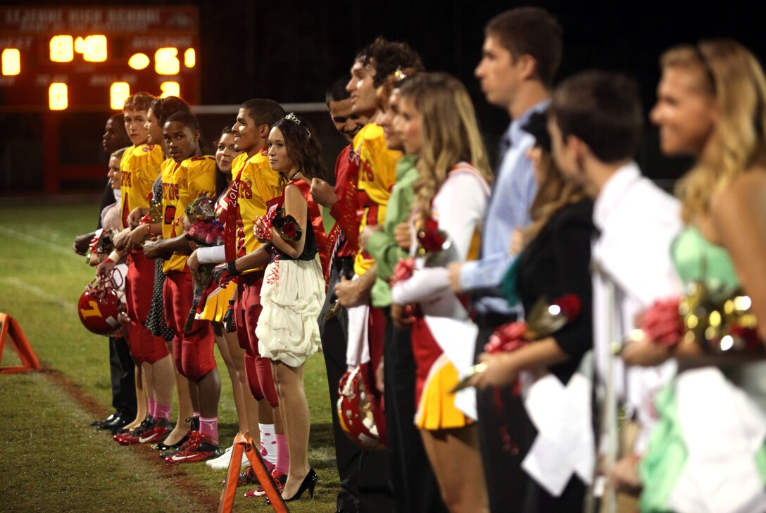 Lejeune High School’s homecoming court stands in front of the crowd as they are each announced over the microphone at halftime during their homecoming game against Pamlico County High School Friday. The freshmen, sophomores and juniors each had four representatives on the court and the senior class had six representatives. Official Marine Corps photo by Lance Cpl. Scott W. Whiting)