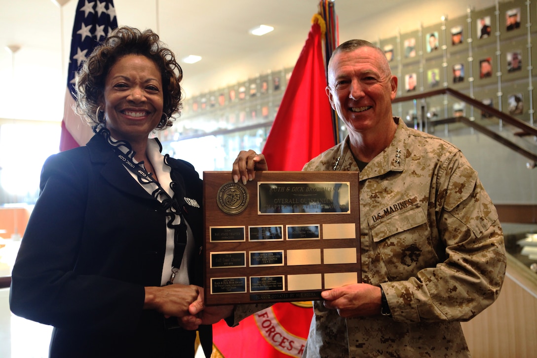 Lt. Gen. Steven A. Hummer, commander of Marine Forces Reserve, accepts an award from Melanie L. Young, president of the Molly Marine chapter of the Women Marines Association, during a ceremony where the local Molly Marine chapter presented MARFORRES with an award plaque at the Marine Corps Support Facility New Orleans, Oct. 15. The Molly Marine chapter was awarded the Ruth and Dick Broe Award, the most prestigious award given to WMA chapters for overall outstanding chapter achievement, at their most recent national convention and professional development conference that took place in Philadelphia from Aug. 30 through Sept. 4. 