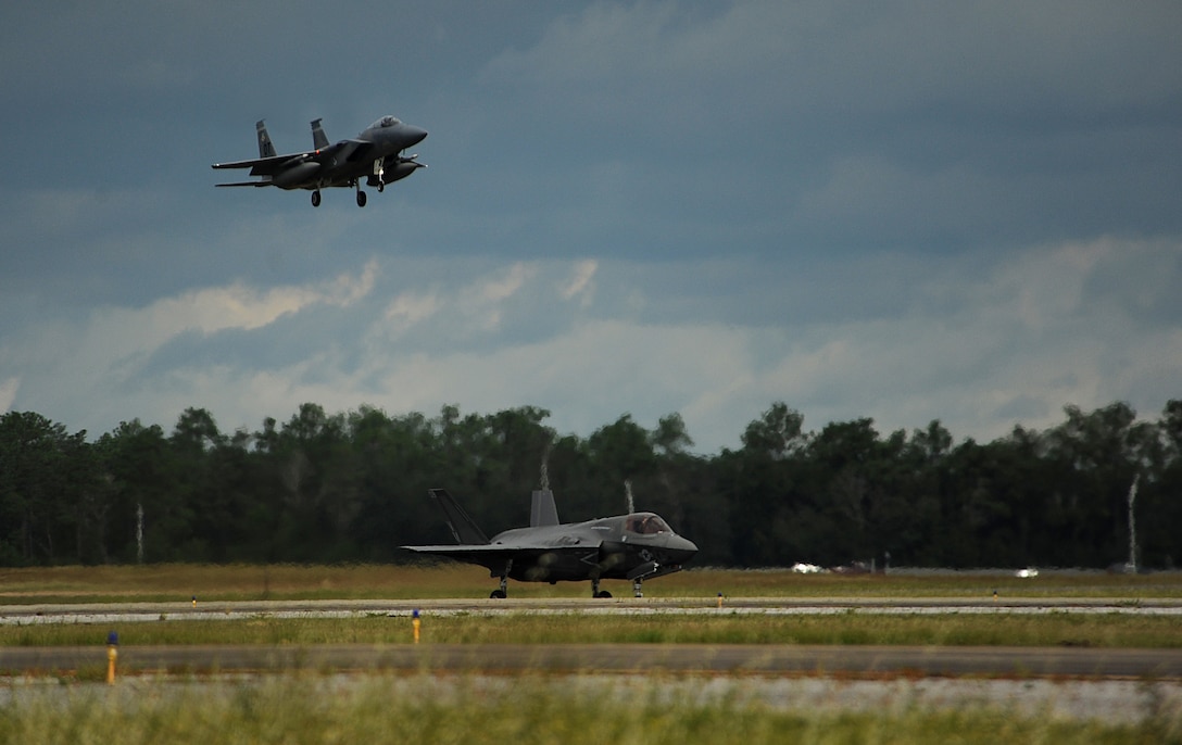 EGLIN AIR FORCE BASE, Fla. - An F-35B Lightning II joint strike fighter from the Marine Fighter Attack Training Squadron 501, Eglin Air Force Base, Fla., sits on the runway waiting for take off clearence for a local training mission over the Emerald Coast Sept. 18, 2012 while an Air Force F-15 Eagles prepares to land. 
