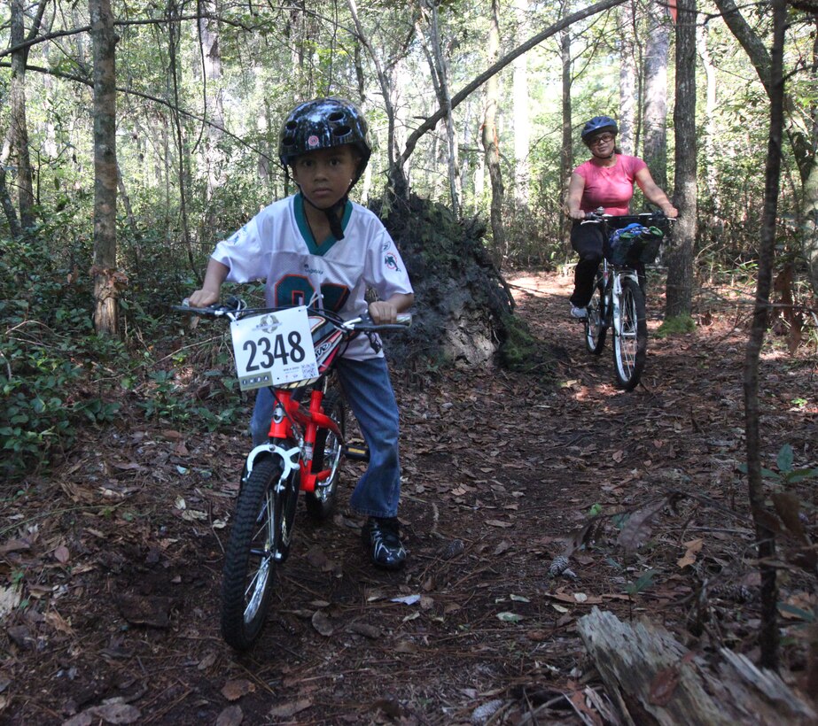 Military family members ride through biking trails during Marine Corp Base Camp Lejeune’s first Take a Kid Mountain Biking Day event hosted by The National Mountain Biking Association at the Henderson recreation area Oct. 6. The event provided group rides for all ages.
