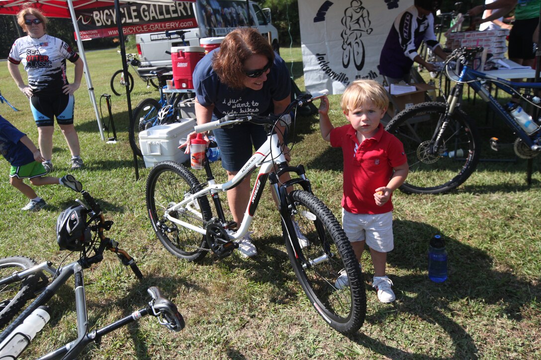 Cindy Evans, a military family member, holds the bike her grandson won during a raffle during Marine Corp Base Camp Lejeune’s first Take a Kid Mountain Biking Day event hosted by The National Mountain Biking Association at the Henderson recreation area Oct. 6. The event was sponsored by Marine Corps Community Services as well as a local bike shop in Jacksonville, donated a bicycle to one lucky boy and girl at the closing of the group ride.