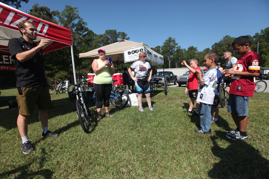 Shawn Kane, a manager of a local bike shop, reads the winning ticket number during a raffle during Marine Corp Base Camp Lejeune’s first Take a Kid Mountain Biking Day event hosted by The National Mountain Biking Association at the Henderson recreation area Oct. 6. The event was sponsored by Marine Corps Community Services as well as a local bike shop in Jacksonville, who donated a bicycle to one lucky boy and girl at the closing of the group ride.
