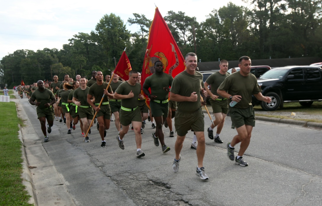 (left to right) Lt. Col. David Bardorf, the commanding officer of Headquarters and Support Battalion, and Sgt. Maj. Michael Rowan, the sergeant major of HQSPTBn., lead their battalion on a run during the annual battalion’s physical training session to support the Combined Federal Campaign at the Goettge Memorial Field House parking lot aboard Marine Corps Base Camp Lejeune Oct. 3. The CFC Onslow County's goal is to reach $1 million during the campaign season which started Sept. 1 through Dec. 15.