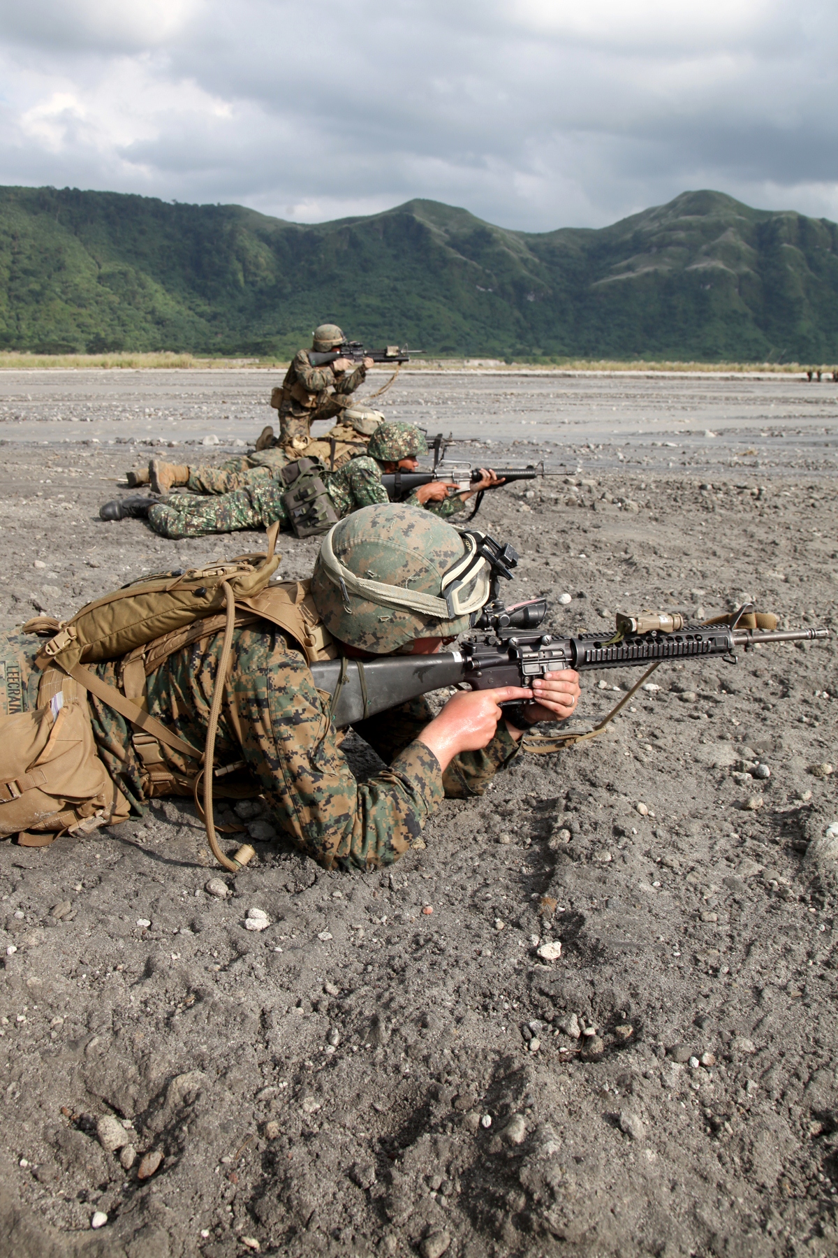 An integrated squad of Marines from Company G., Battalion Landing Team 2nd Battalion, 1st Marine Regiment, and Philippine Marines of the 33rd Battalion, 33rd Marine Company, provide security at the end of a helicopter raid exercise here, Oct. 14. The training was part of the 29th iteration of the annual Philippines Bilateral Amphibious Landing Exercise, designed to increase interoperability between U.S. and Philippine forces while strengthening their long standing bond.
