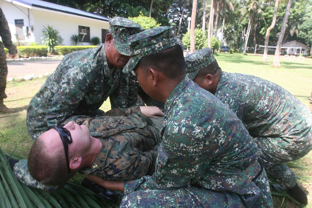 Philippine Marine Corps corpsmen demonstrate how to use an improvised stretcher Oct. 12 as part of the bilateral Amphibious Landing Exercise (PHIBLEX) 2013. PHIBLEX is a bilateral training exercise hosted annually in the Republic of the Philippines to enhance interoperability and readiness of Armed Forces of the Philippines and U.S. Forces. Training exercises like this are critical to maintaining our readiness and improving our forces ability to integrate should there be a humanitarian assistance or disaster relief scenario.