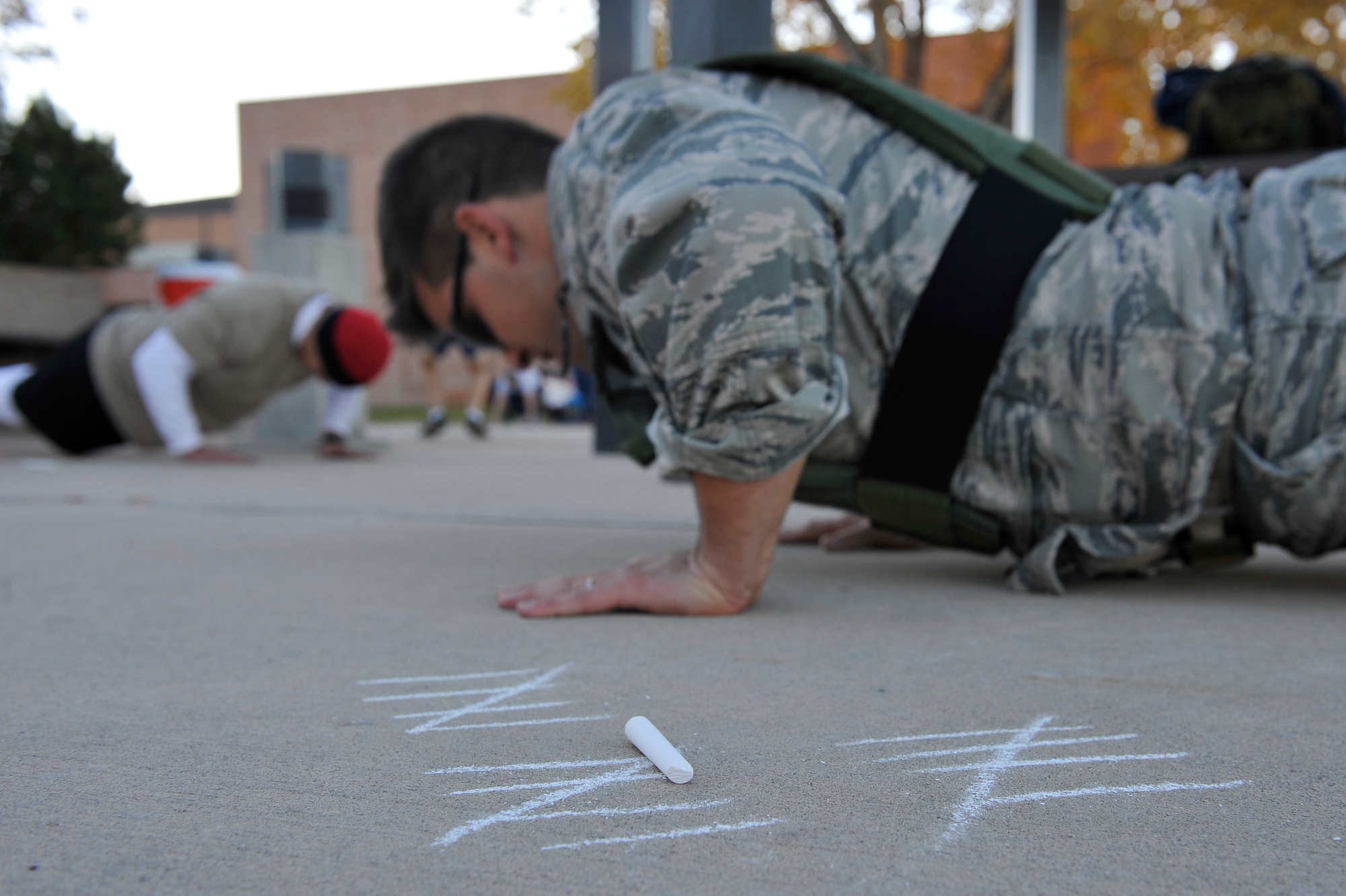 Members of Peterson Air Force Base participate in the Airman 1st Class
LeeBernard E. Chavis memorial workout Oct. 16.  The workout is an annual
event continued by Chavis' friends world-wide to commemorate his death on
Oct. 14, 2006, in the streets near Baghdad, Iraq.  Workout participants used
chalk to keep track of their repetitions during the difficult workout. (U.S.
Air Force photo by SSgt Christopher Boitz)  
