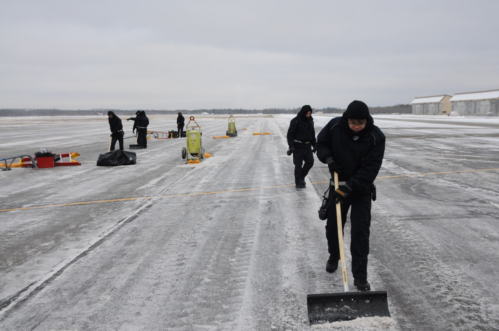 Personnel assigned to the 428th Fighter Squadron shovel snow on the flight line Oct. 17, 2012, at Eielson Air Force Base, Alaska. The constant snowfall caused ground crew members to shovel throughout the day. (U.S. Air Force photo/Senior Airman Benjamin Sutton/Released)  