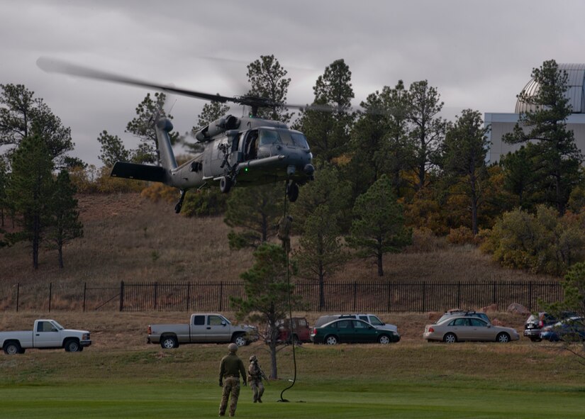 Pararescuemen from the 48th Rescue Squadron rappel down from an HH-60G Pave Hawk during personnel recovery training at the U.S. Air Force Academy, Colo., Oct. 4, 2012. The 563d Rescue Group visited the Academy to help showcase the personnel recovery mission to cadets . (U.S. Air Force photo by Senior Airman Nicholas Benroth/Released)