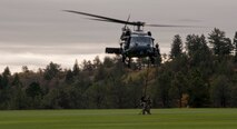 Airmen from the 563d Rescue Group climb into an HH-60G Pave Hawk after rescuing a downed pilot and fighting off an aggressor during personnel recovery training at the U.S. Air Force Academy, Colo., Oct. 4, 2012. The demonstration included a tactical insertion by the rescue team, aerial support and an extraction of a downed pilot. (U.S. Air Force photo by Senior Airman Nicholas Benroth/Released)