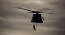 A pararescueman from the 48th Rescue Squadron is hoisted into an HH-60G Pave Hawk while holding a simulated downed pilot during a personnel recovery demonstration practice at the U.S. Air Force Academy, Colo., Oct. 4, 2012. The demonstration showcased the Air Force’s personnel recovery capabilities. (U.S. Air Force photo by Senior Airman Nicholas Benroth/Released)