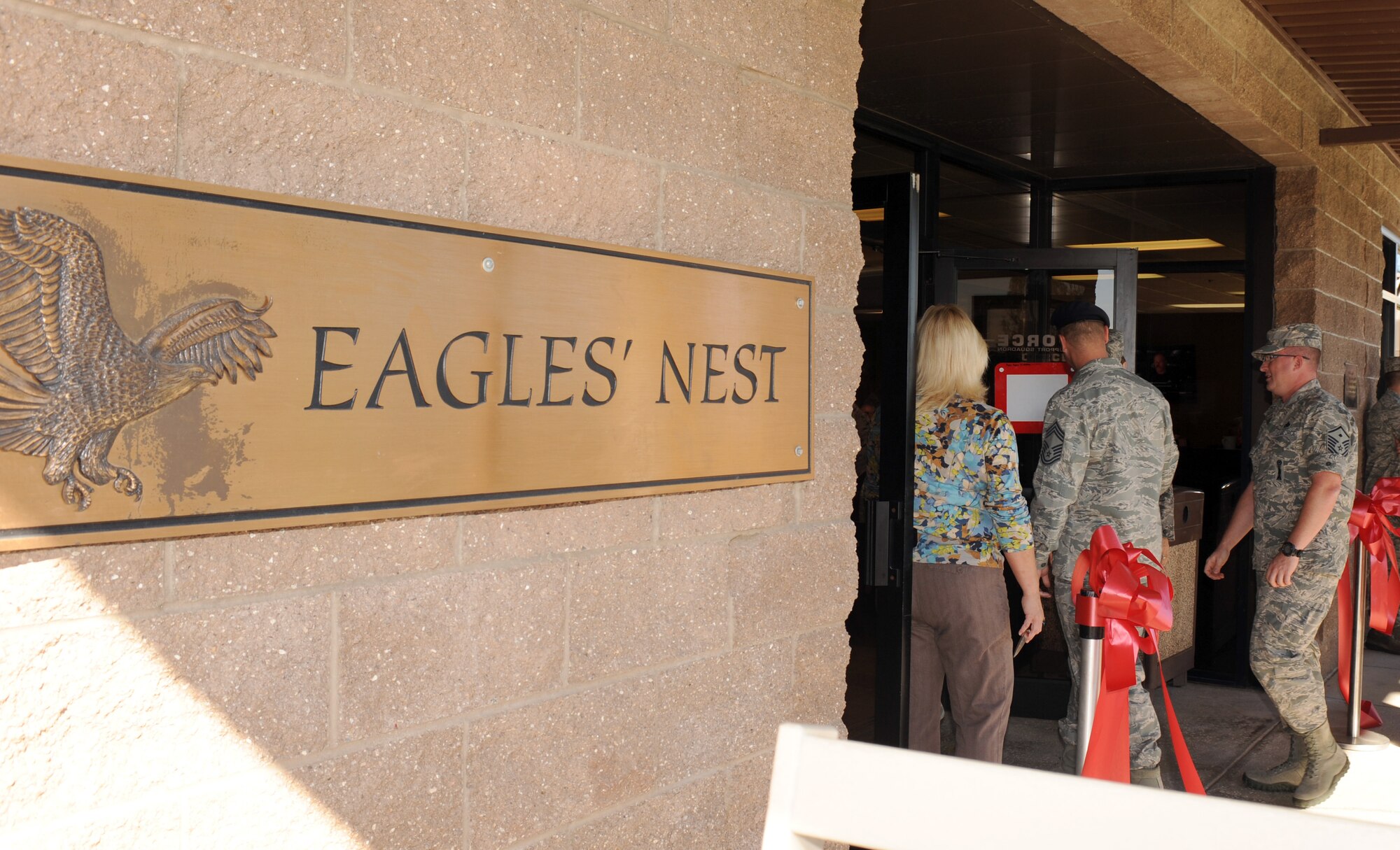 U.S. Air Force Airmen walk into the Eagle's Nest Snack Bar and Grill after its re-opening on Davis-Monthan Air Force Base, Ariz., Oct. 16, 2012. The Eagle's Nest provides another dining choice for the Desert Lightning Team and community. Along with a new look and menu items, the cafe has also updated the way customers are served. Customers can now sit and relax as their orders are brought to them. (U.S. Air Force photo by Senior Airman Timothy Moore/Released)