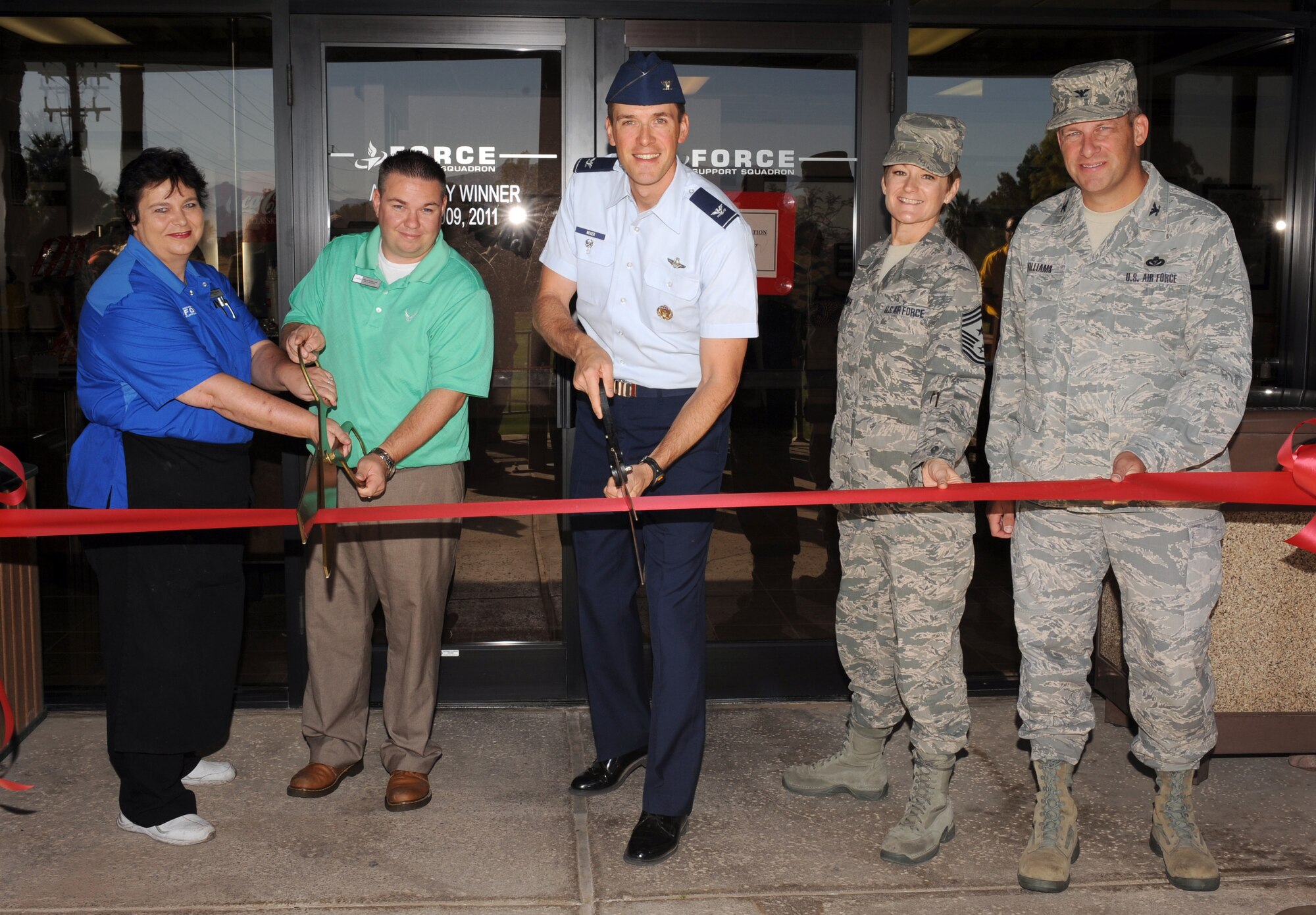 U.S. Air Force Col. James Meger, 355th Fighter Wing vice commander, leads the ribbon cutting for the re-opening of the Eagle's Nest Snack Bar and Grill at Blanchard Golf Course on Davis-Monthan Air Force Base, Ariz., Oct. 16, 2012. The Eagle's Nest has updated its look as well as its menu to include healthier food choices. (U.S. Air Force photo by Senior Airman Timothy Moore/Released)