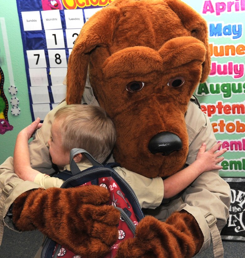 Hugs weren't the only things given out as part of Crime Prevention
Month activities held at Woodman Hills Elementary School on Oct. 11.
Scruff McGruff the Crime Fighting Dog and members of the 21st Security
Forces Squadron at Peterson AFB provided materials, stickers and education
on stranger danger. (U.S. Air Force photo/ Duncan Wood)

